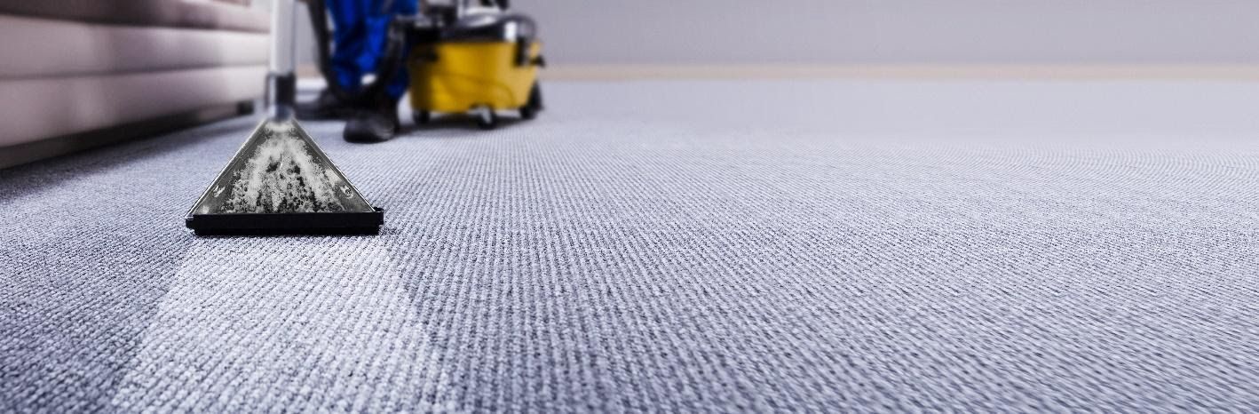 vacuum cleaner cleaning a carpeted floor