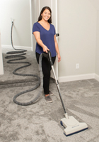 Woman using Central Vacuum with Turbocat Powerhead